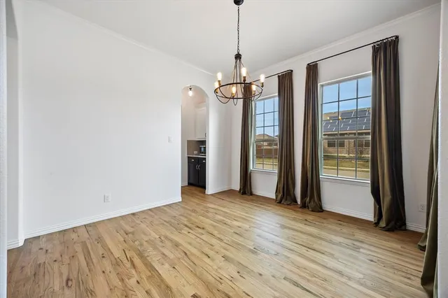 a view of a room with a flat screen tv and refrigerator