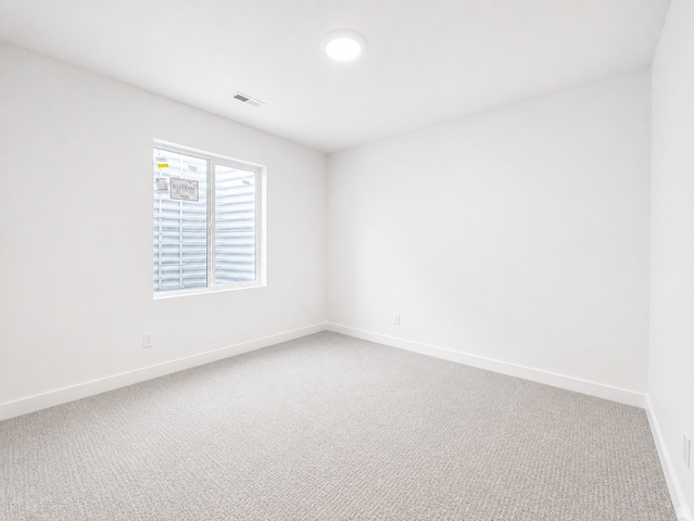 1004 West Paramount Cove South, Unit 315 Ogden, UT 84405 - Photo 33 of 42 Basement bedroom featuring light gray carpeting, white walls, and white baseboards