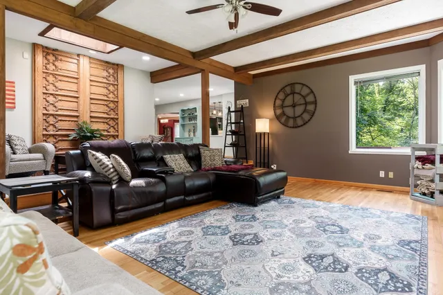 a living room with furniture and floor to ceiling windows