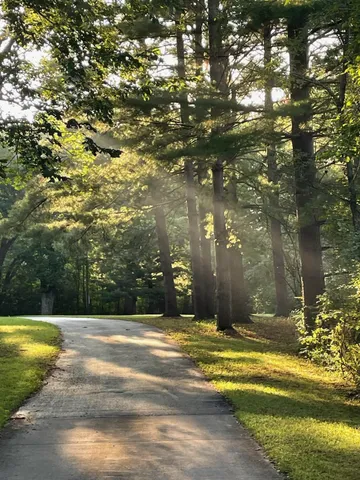 a large kitchen with stainless steel appliances granite countertop a stove refrigerator and a kitchen island