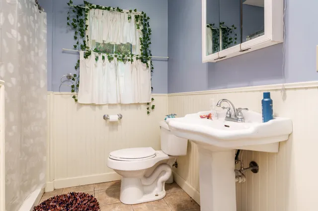 a kitchen with a sink stove top oven and cabinets