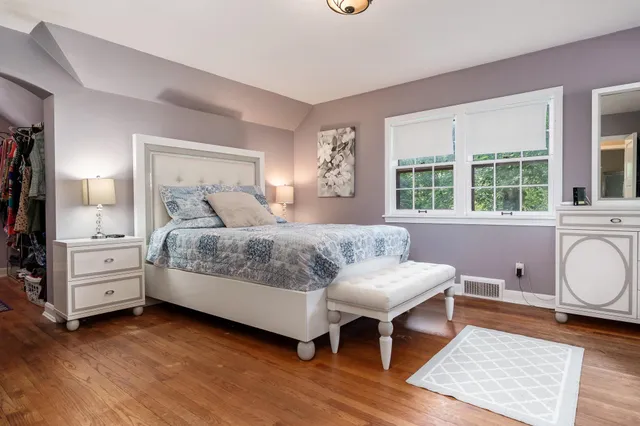 a bed room with a bed and a painting on the wall