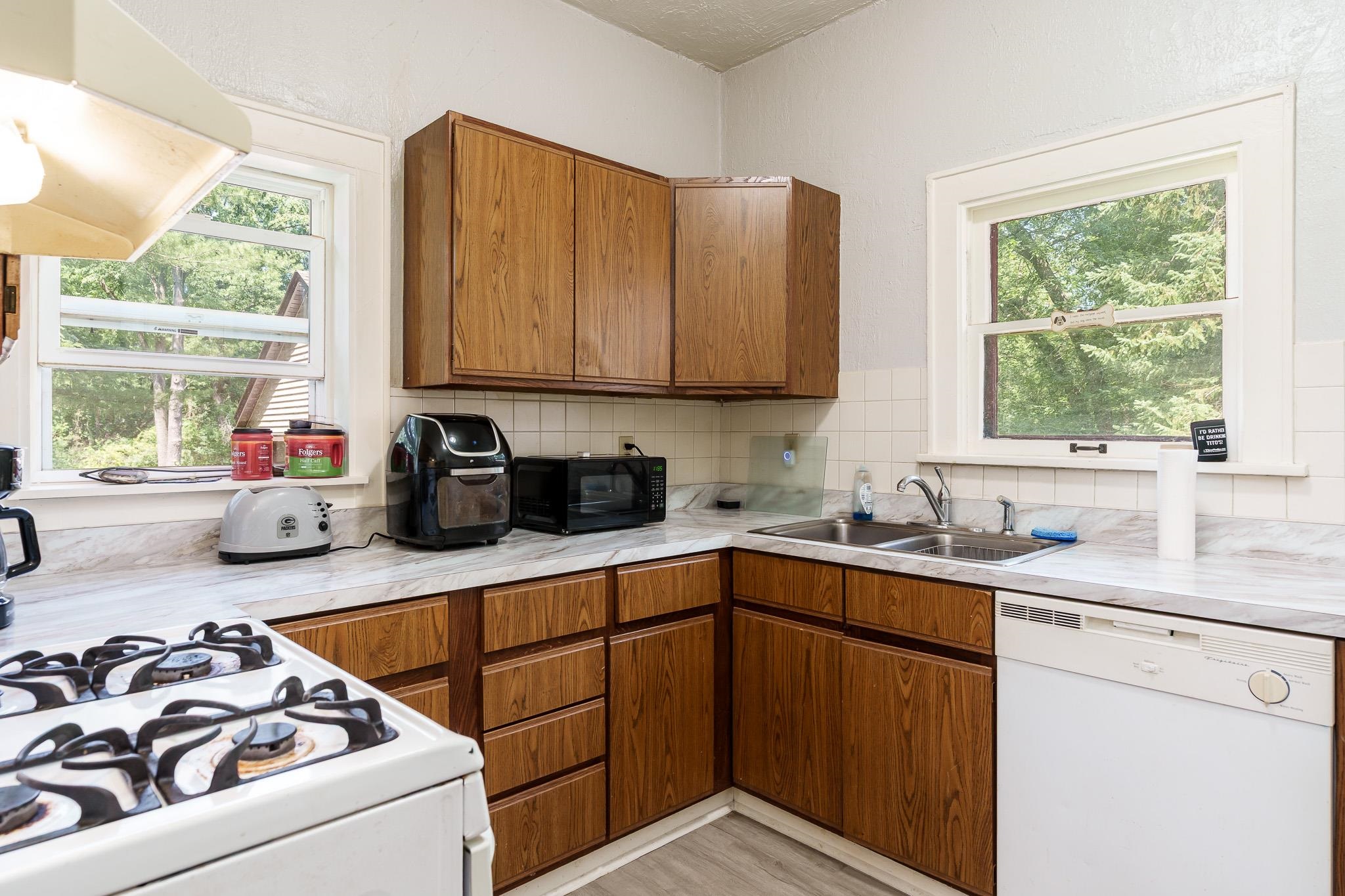 2373 Geddes Road Rockford, IL 61103 - Photo 69 of 97 a kitchen with a sink stove top oven and cabinets