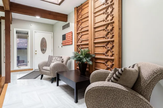 a aerial view of a house with a yard and large trees