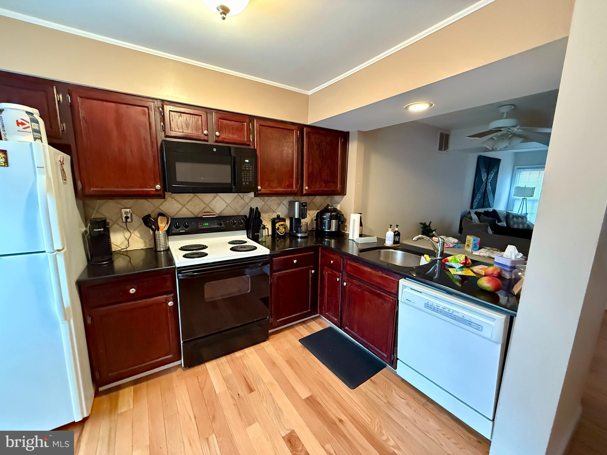 2454 South Walter Reed Drive, Unit D Arlington, VA 22206 - Photo 2 of 11 a kitchen with a sink cabinets and stainless steel appliances