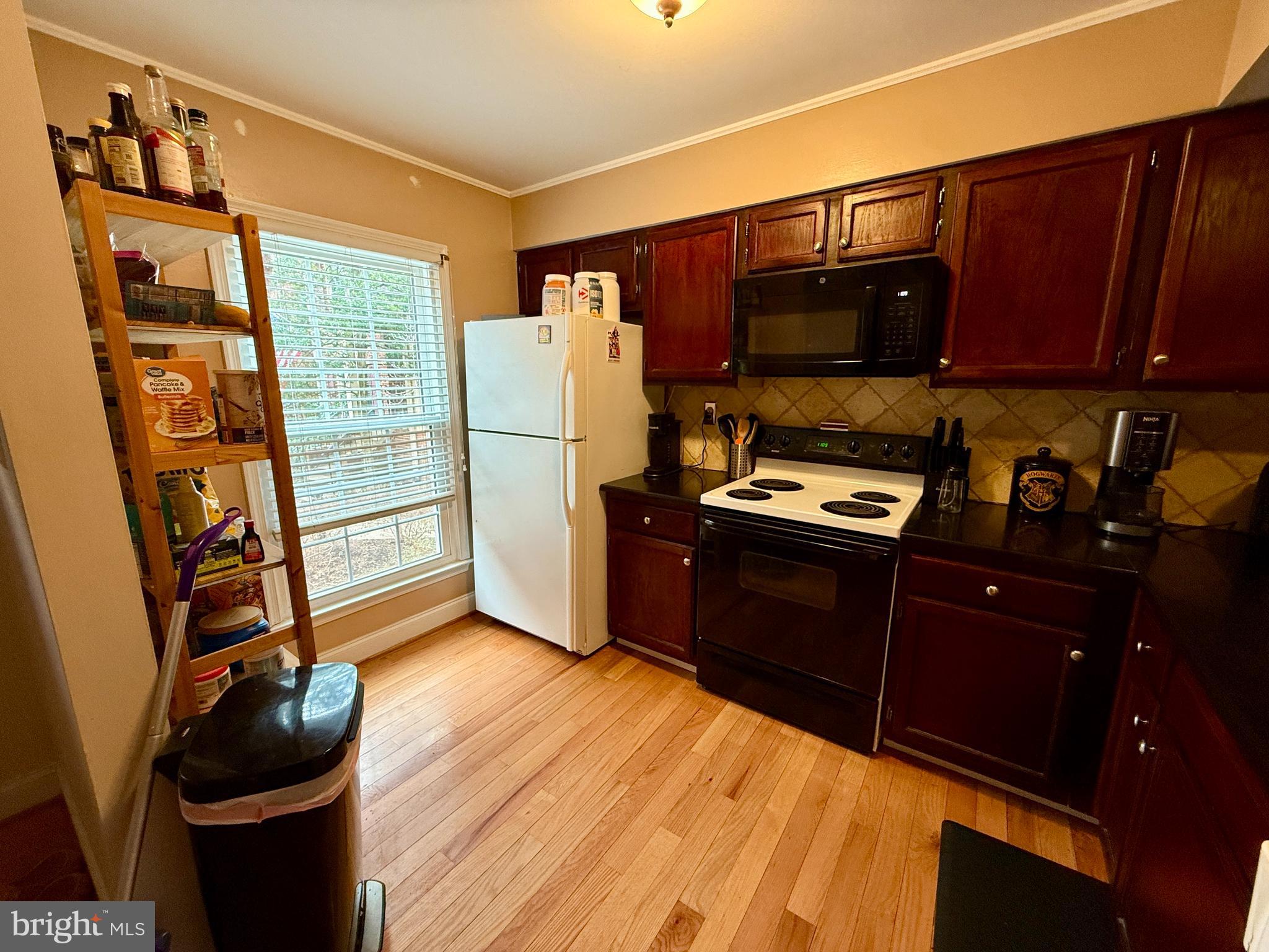 2454 South Walter Reed Drive, Unit D Arlington, VA 22206 - Photo 3 of 11 a kitchen with stainless steel appliances a refrigerator and a stove top oven