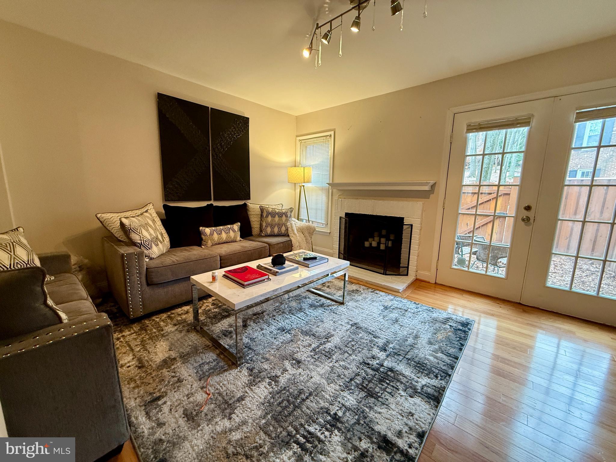 2454 South Walter Reed Drive, Unit D Arlington, VA 22206 - Photo 5 of 11 a living room with furniture and a fireplace