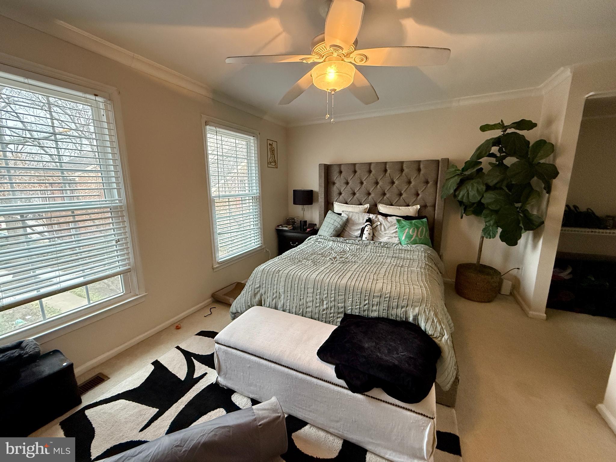 2454 South Walter Reed Drive, Unit D Arlington, VA 22206 - Photo 6 of 11 a bedroom with a bed and a chandelier