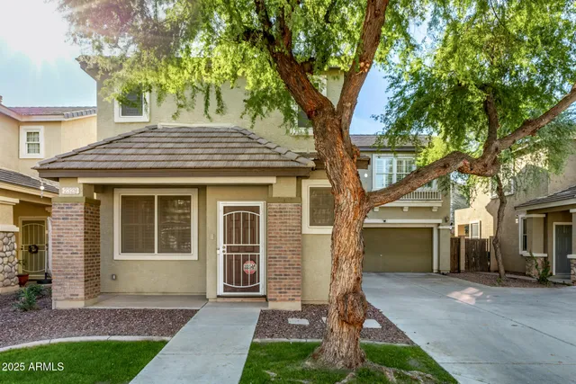 a front view of a house with a garden