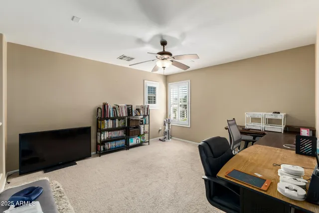 a bedroom with furniture and a flat screen tv