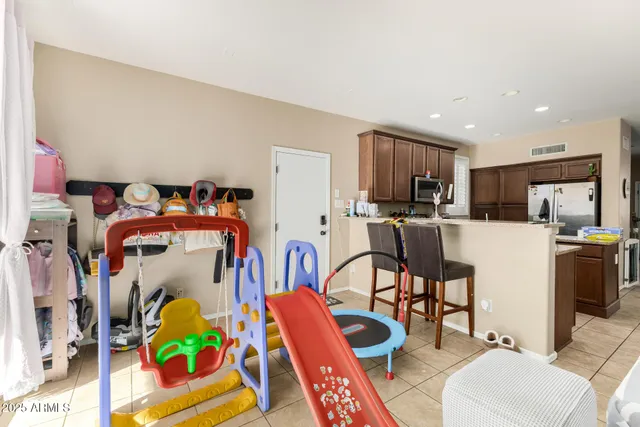 a living room filled with furniture appliances and a kitchen