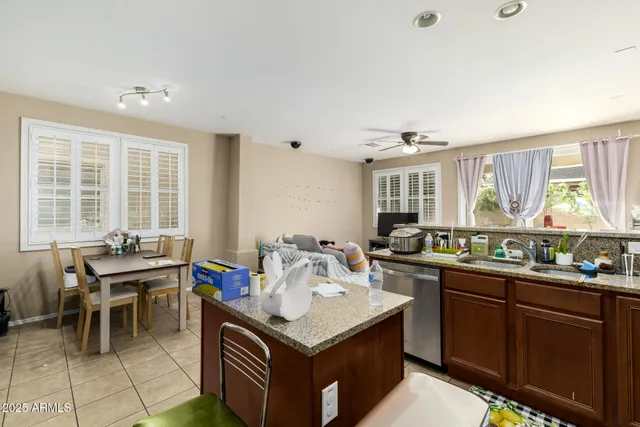 a kitchen with a stove a sink a dining table and chairs