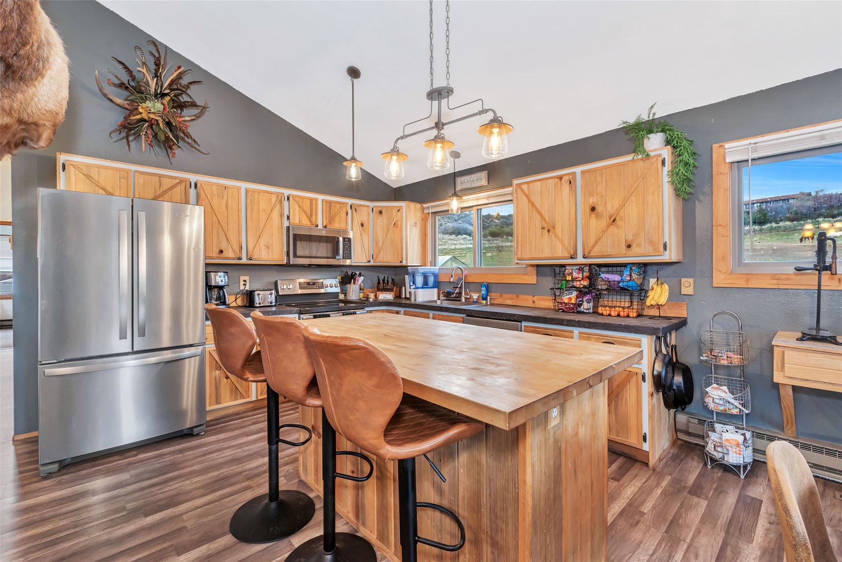 224 C R 206 Craig, CO 81625 - Photo 3 of 50 a kitchen with stainless steel appliances granite countertop a refrigerator a sink dishwasher a stove and a dining table with wooden floor