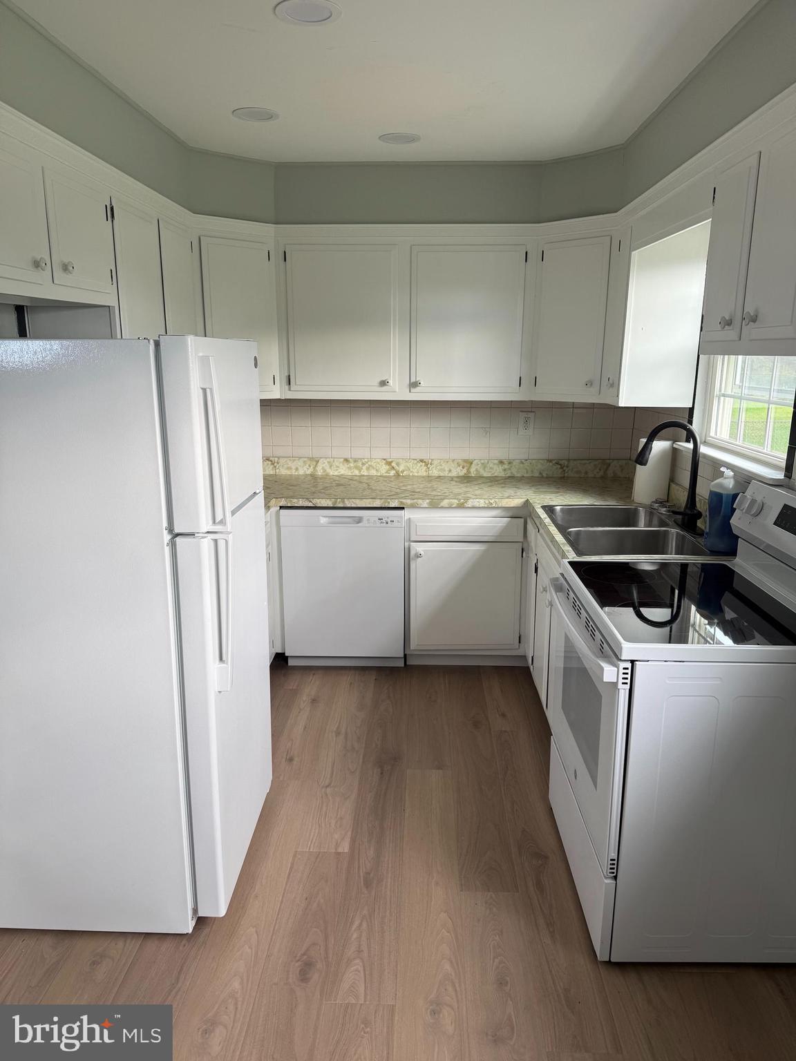 810 South Harmony Road Newark, DE 19713 - Photo 7 of 18 a kitchen with stainless steel appliances granite countertop a refrigerator a sink and white cabinets