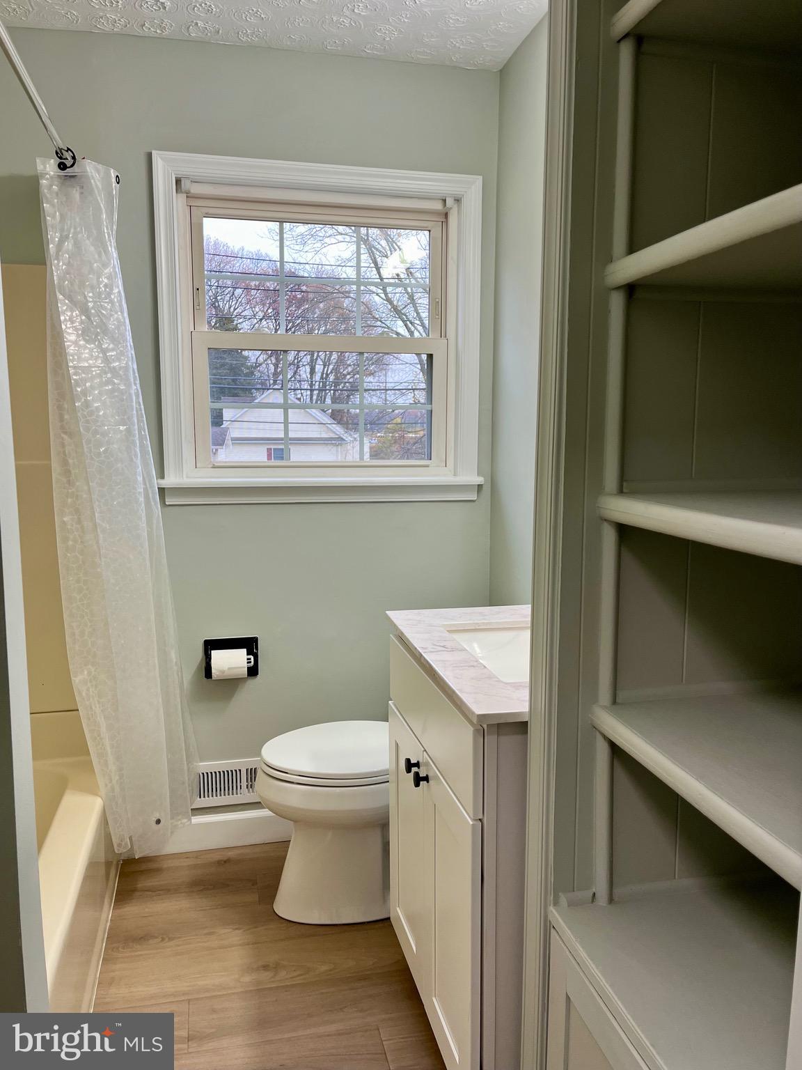 810 South Harmony Road Newark, DE 19713 - Photo 9 of 18 a bathroom with a toilet a sink and a window