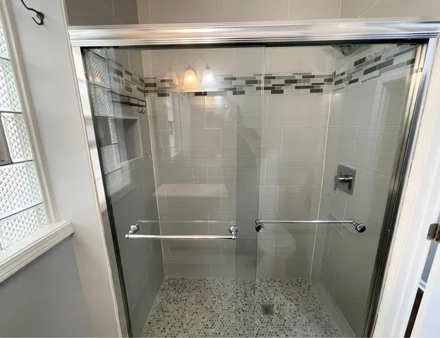 a bathroom with a glass door shower