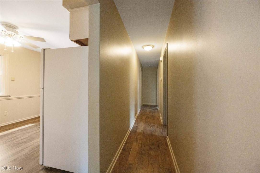 1586 Norledge Road Akron, OH 44305 - Photo 13 of 24 Corridor with wood laminate floors and freshly painted a warm neutral