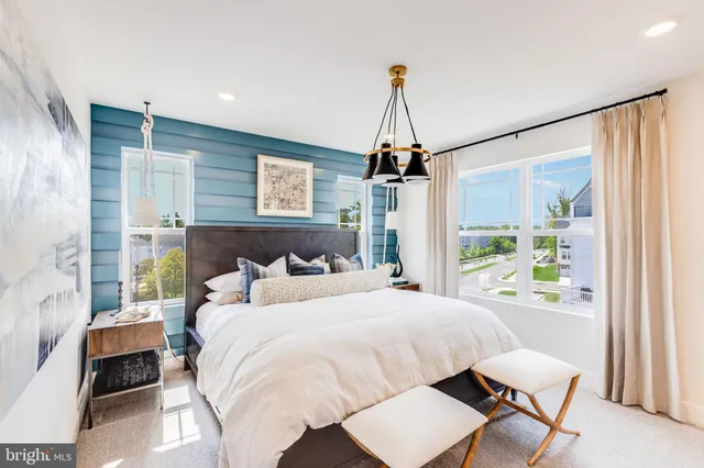 a bedroom with a bed window and a table