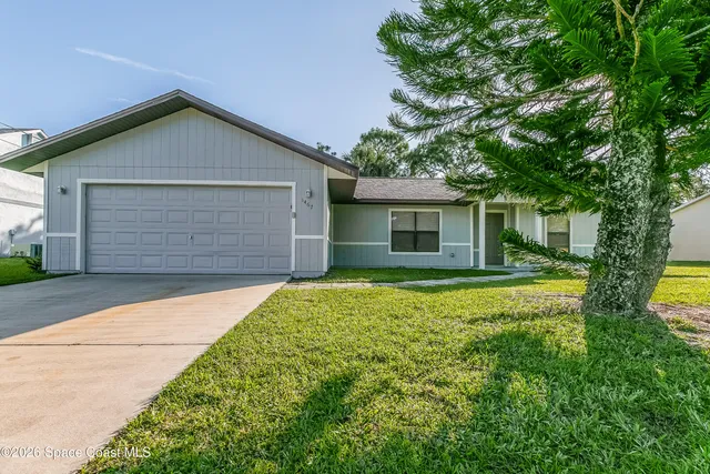 a front view of house with yard and green space