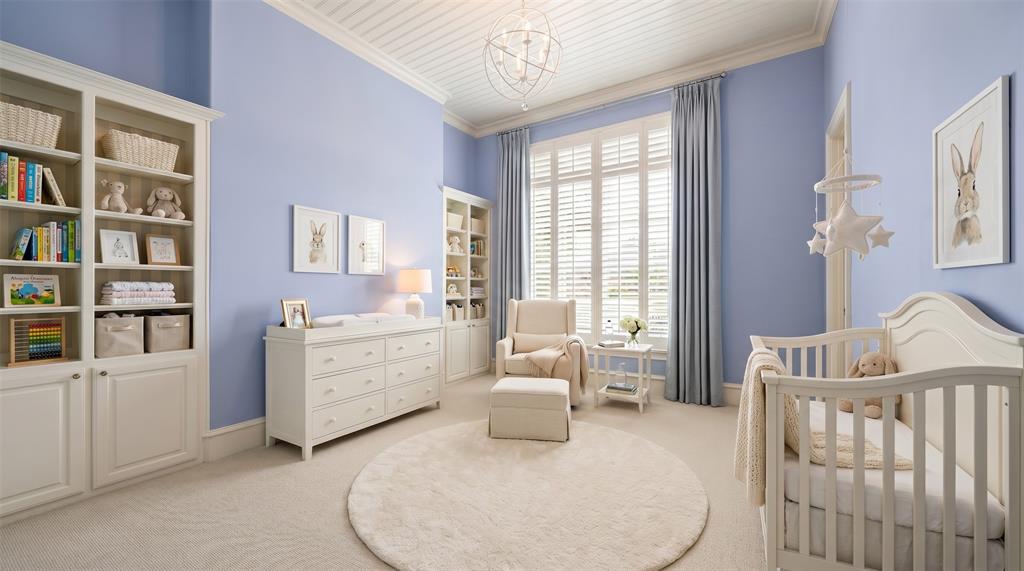 6900 Rockingham Court Colleyville, TX 76034 - Photo 18 of 40 Light blue walls with extensive white trim and crown molding with plantation shutters and floor length drapes. Ai staged for a nursery.