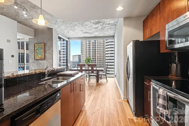 a kitchen with stainless steel appliances a refrigerator and a stove top oven