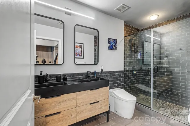 a bathroom with a toilet a sink and mirror