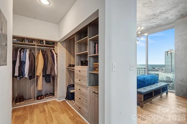 a view of walk in closet with clothes and shoes