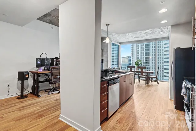 a kitchen with stove and wooden floor