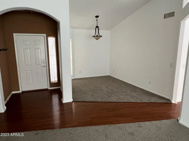 an empty room with wooden floor and closet