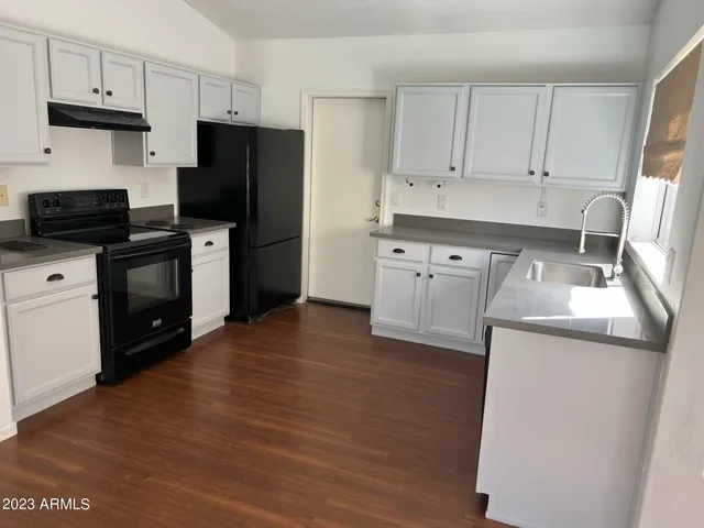 a kitchen with stainless steel appliances a refrigerator stove and sink