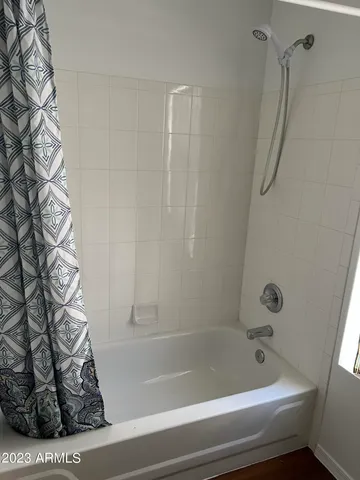 a bathroom with a bathtub and shower