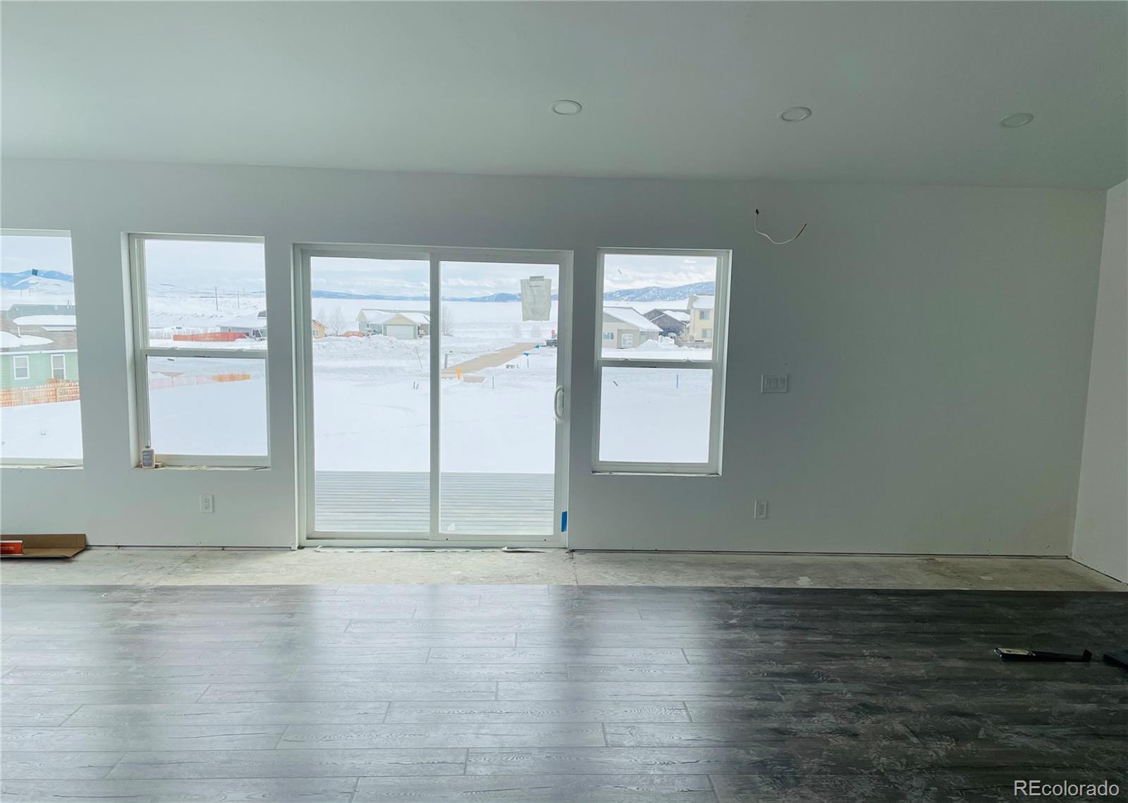 361 Lake View Road Hayden, CO 81639 - Photo 10 of 11 an empty room with wooden floor and windows