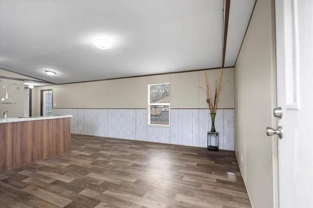 a view of a field with large trees