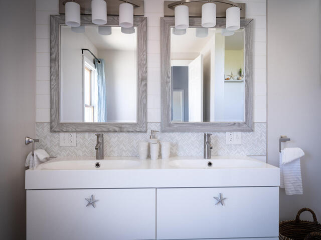 33 Bartlett Road Nantucket, MA 02554 - Photo 18 of 29 a bathroom with double vanity sink and two mirror