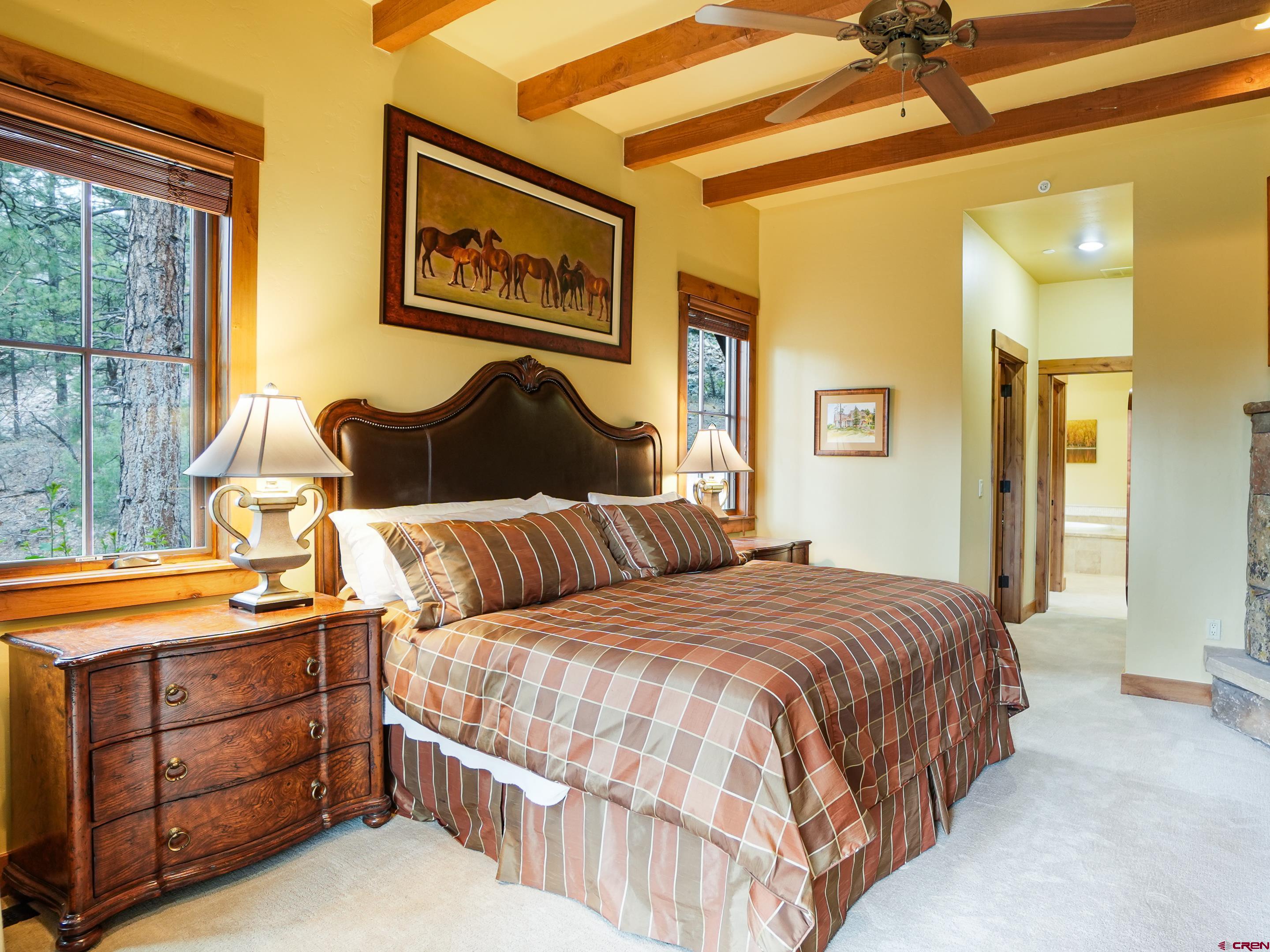77 Ambush Canyon Durango, CO 81301 - Photo 12 of 25 a bedroom with a bed and a lamp on dresser