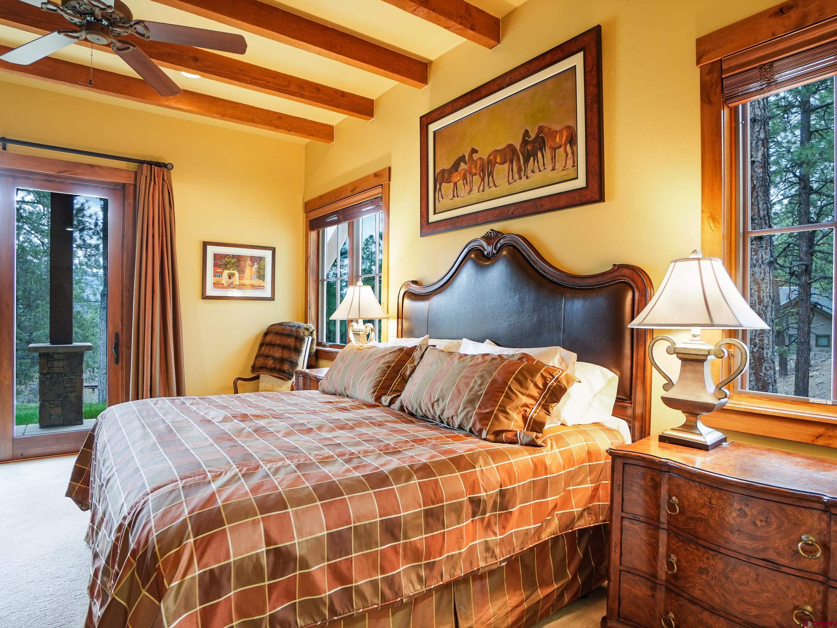 77 Ambush Canyon Durango, CO 81301 - Photo 13 of 25 a bedroom with a bed and a painting on the wall