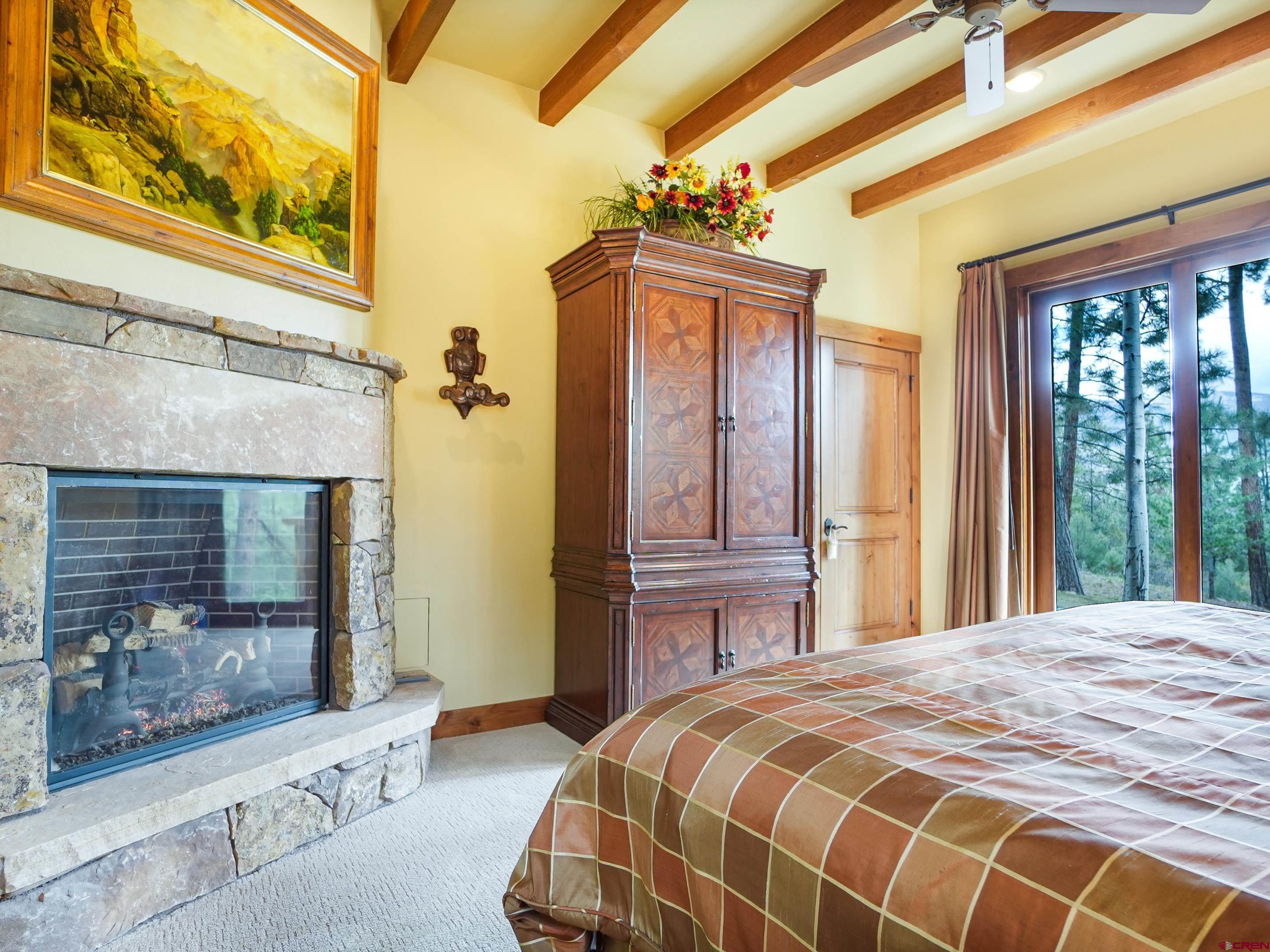 77 Ambush Canyon Durango, CO 81301 - Photo 14 of 25 a bedroom with a bed and a dresser next to a window