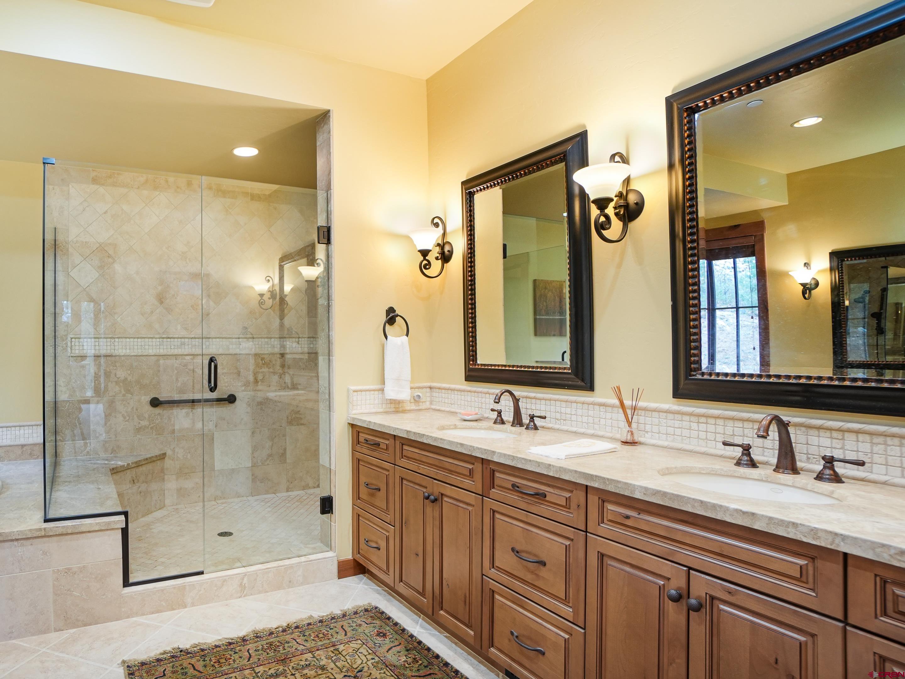77 Ambush Canyon Durango, CO 81301 - Photo 15 of 25 a bathroom with a shower sink and mirror