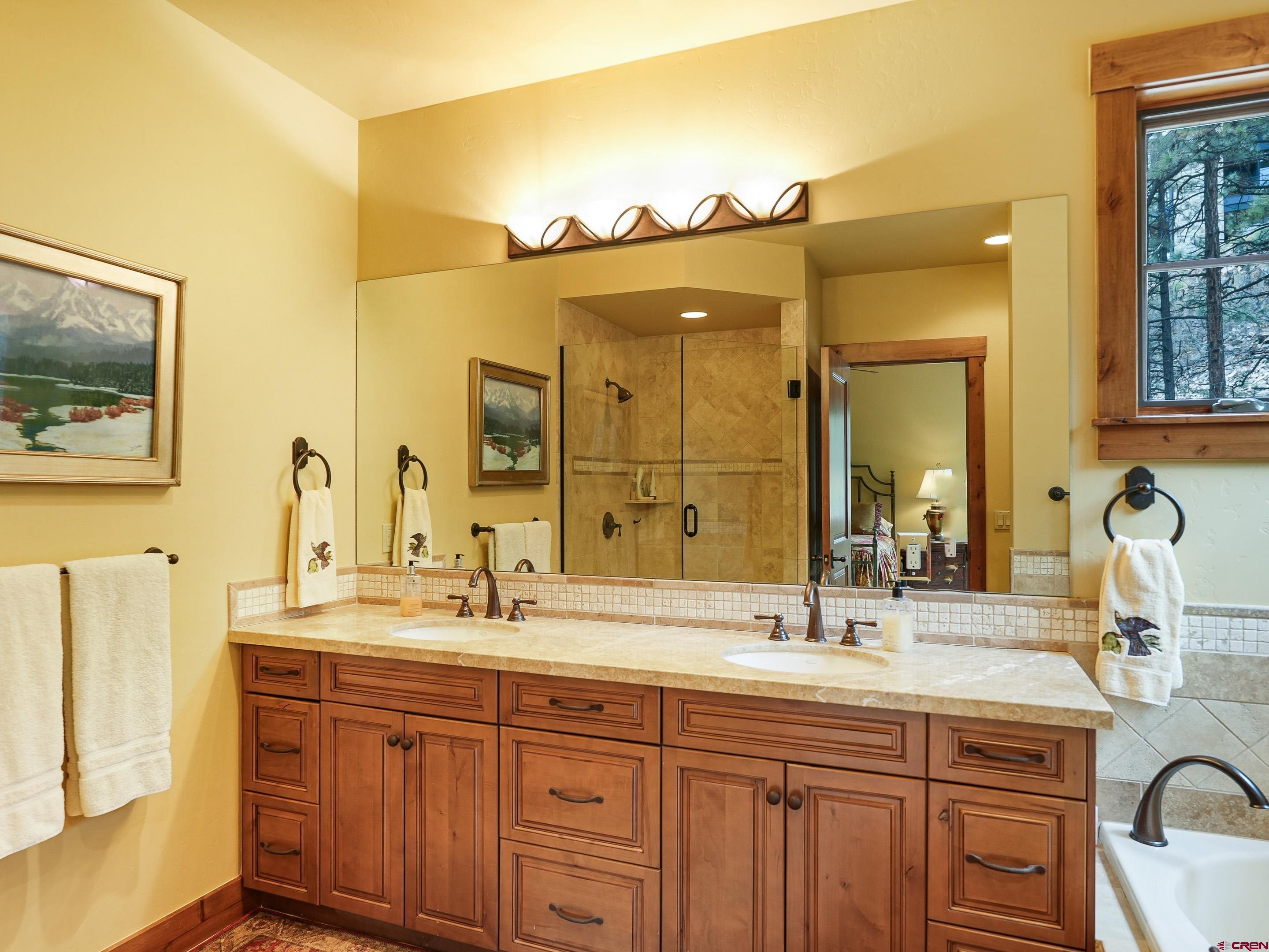 77 Ambush Canyon Durango, CO 81301 - Photo 18 of 25 a bathroom with a double vanity sink and a mirror