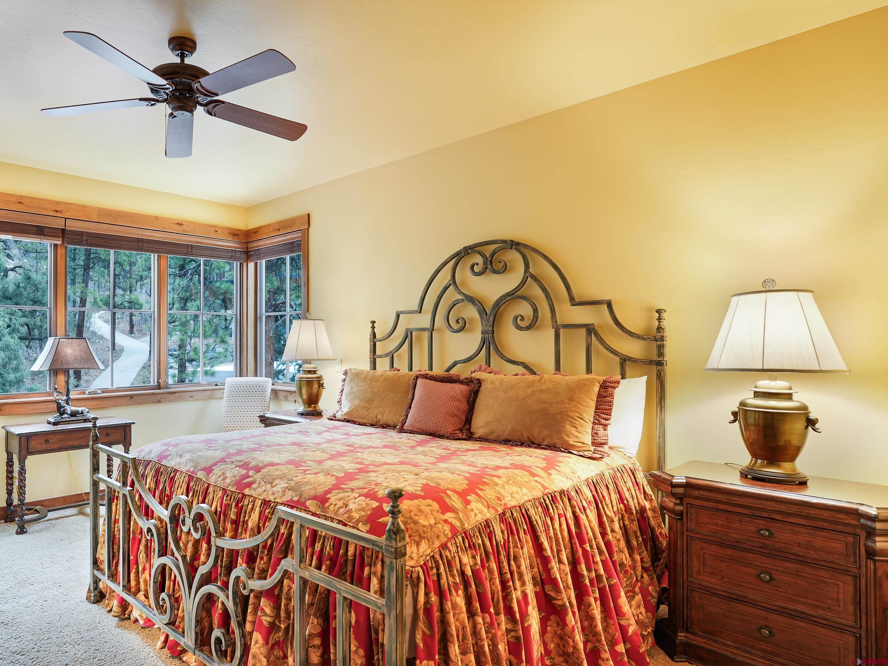 77 Ambush Canyon Durango, CO 81301 - Photo 19 of 25 a bedroom with a bed and a chandelier