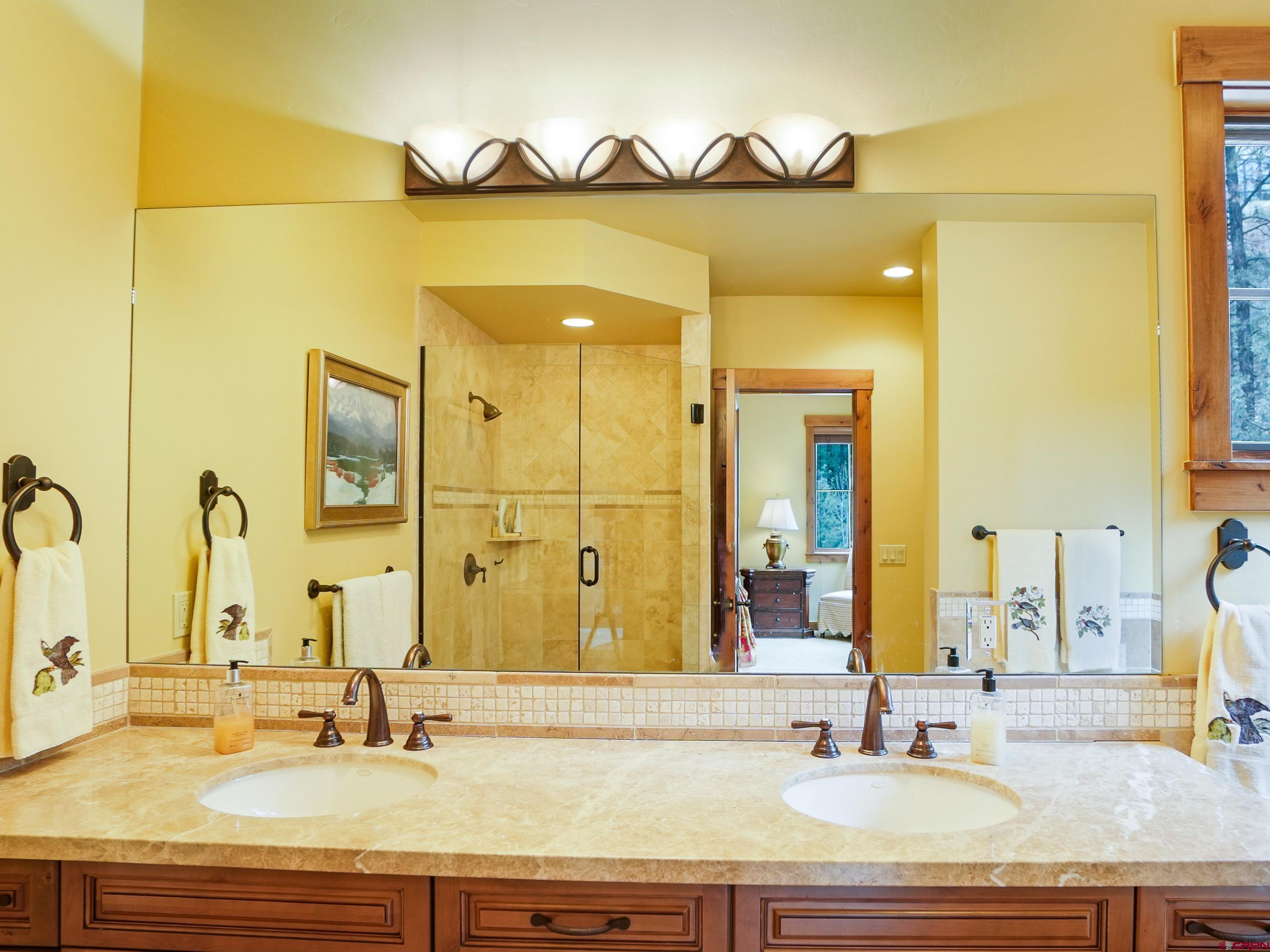 77 Ambush Canyon Durango, CO 81301 - Photo 20 of 25 a bathroom with a granite countertop sink and a mirror