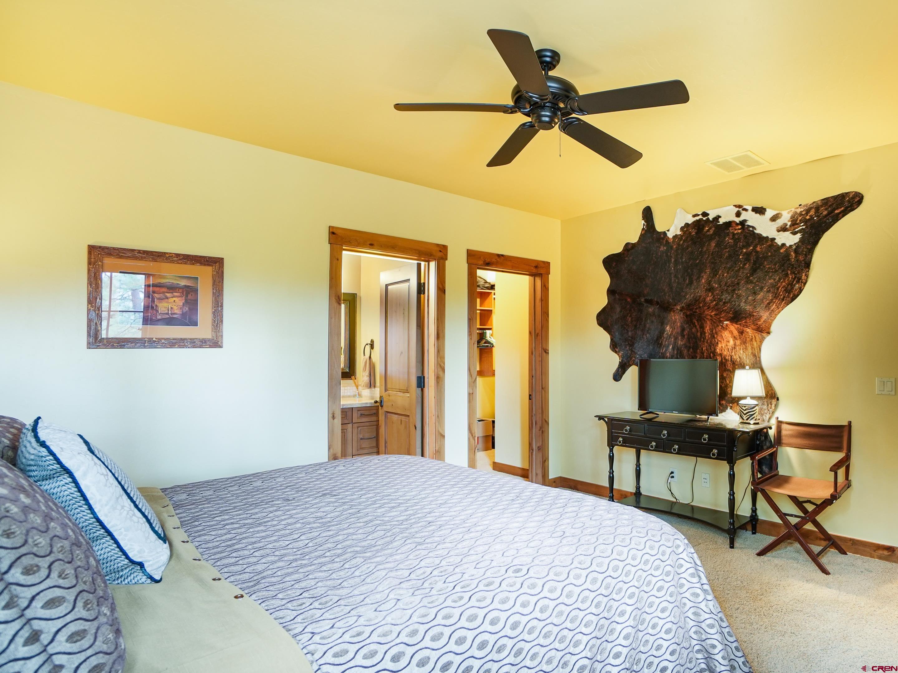 77 Ambush Canyon Durango, CO 81301 - Photo 21 of 25 a bedroom with a bed and a chandelier