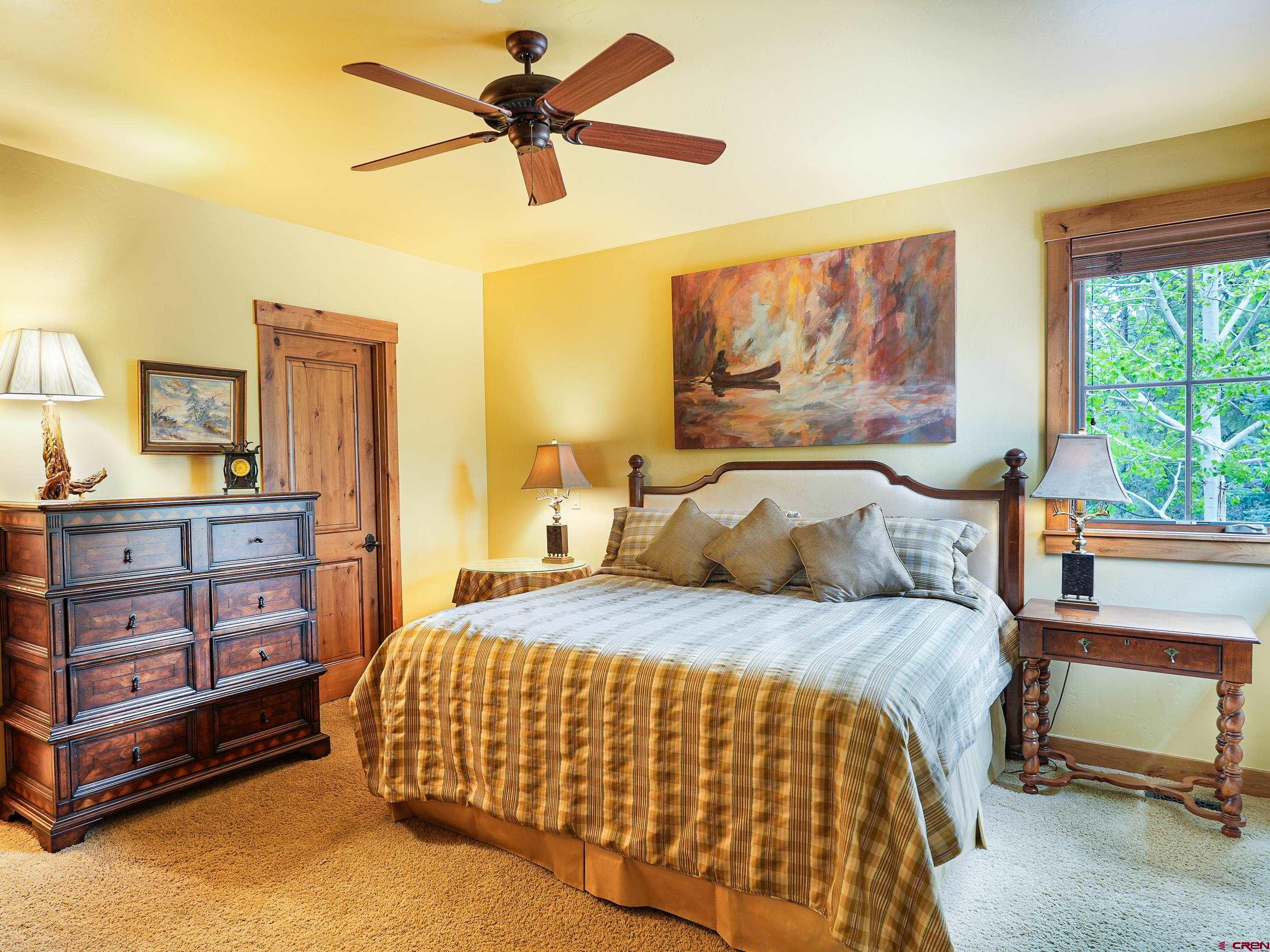77 Ambush Canyon Durango, CO 81301 - Photo 22 of 25 a bedroom with a bed and a painting on the wall