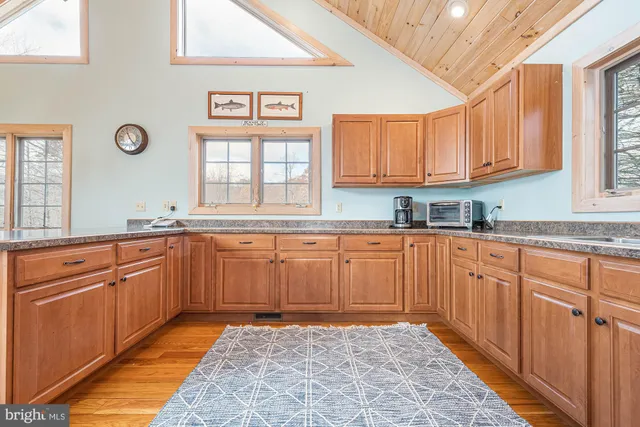 a bedroom with a bed and a dresser next to a window