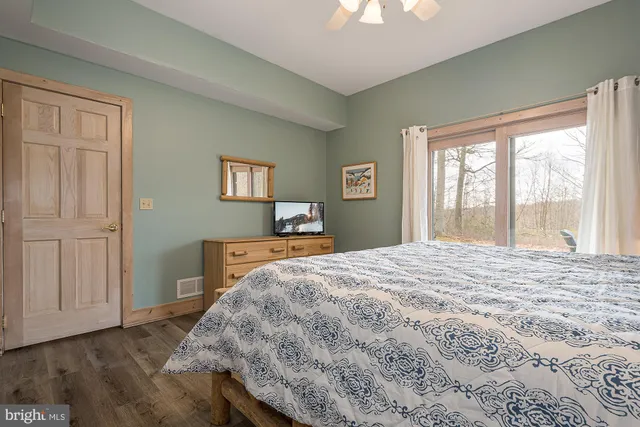 a bedroom with furniture and a book shelf