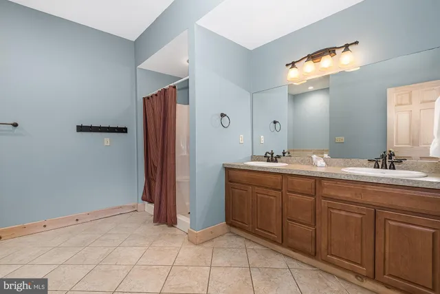 a bathroom with a granite countertop sink toilet a shower and a mirror