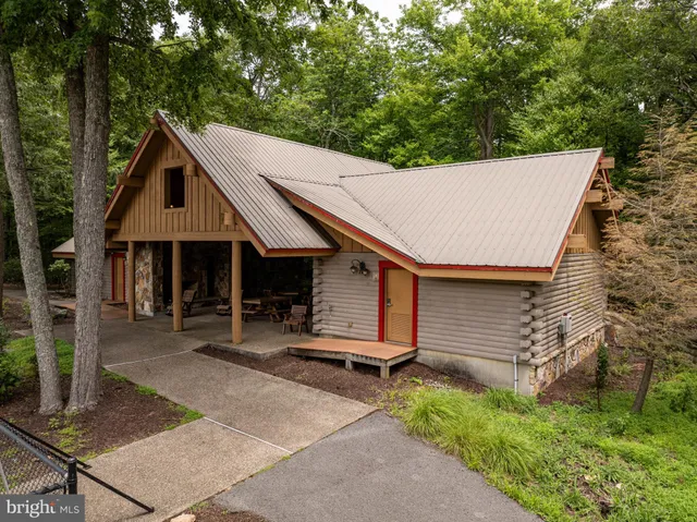 a blue sign that is sitting in the middle of a forest