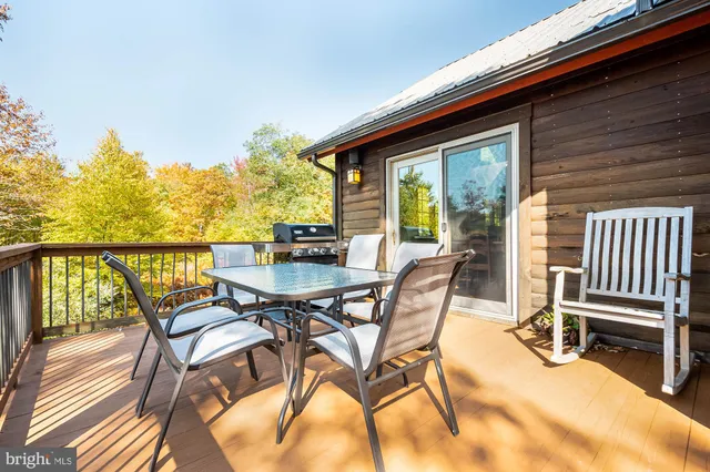 a living room with furniture a rug and a lamp