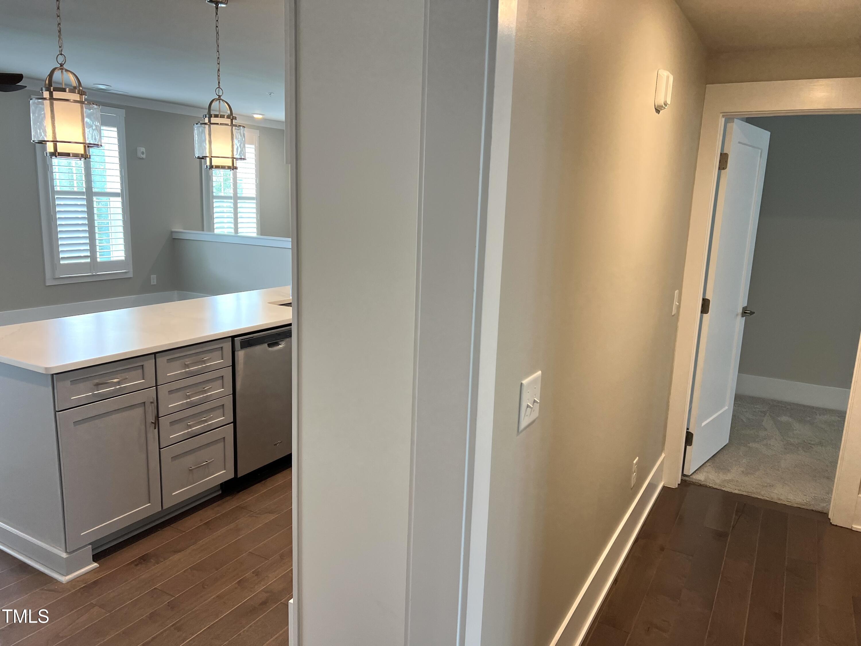 10530 Sablewood Drive, Unit 113 Raleigh, NC 27617 - Photo 17 of 61 a hallway with windows and chandelier
