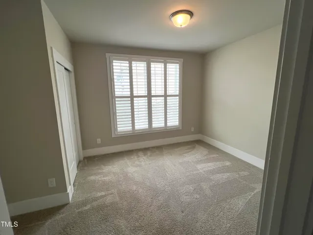 a view of hallway with wooden floor